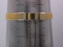 Close-up of the adjustable gold tone mesh bracelet clasp on a wrist sizing gauge, showing it set at approximately 155mm.