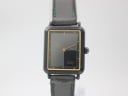 Front view of the Seiko 2P20-5470 watch, showing the black rectangular dial, gold inner bezel, and black leather strap.
