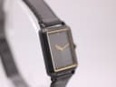 Another angled side view of the Seiko watch, highlighting the minimalist black dial and gold accents.