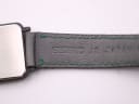 Close-up of the black leather strap, showing the embossed Seiko logo and green stitching.