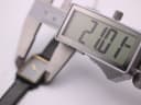 Digital caliper measuring the case width of the Seiko watch, displaying 21.07mm.