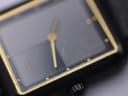 Close-up of the watch dial and acrylic crystal, revealing multiple scratches on the crystal surface.