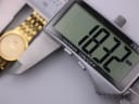 Digital caliper display showing the watch case diameter precisely measured at 18.32mm.