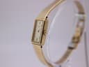 Side view of the Seiko watch showing the crown and the delicate gold mesh bracelet.
