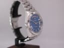 Another side view of the Cadisen watch on a stand, highlighting the polished case and the bracelet links.