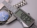 Digital caliper measuring the case diameter of the Cadisen watch, displaying 40.32mm.