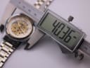 Digital caliper measuring the case diameter of the Winner watch, displaying a precise measurement of 40.36mm.