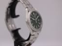 Angled side view of the Seiko watch, highlighting the rotating bezel with minute markers and case shape.