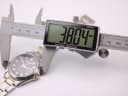 Close-up of a digital caliper measuring the watch case diameter at 38.04mm.