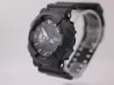 Angled right side view of the Casio G-Shock GA-110 on a watch stand, showing pushers.