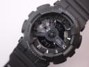 Close-up detail of the Casio G-Shock GA-110 black ana-digi dial with silver-tone accents and digital display.