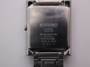 Close-up of the brushed stainless steel case back of the Seiko GLX, showing model, serial, and "Water Resistant" engraving.