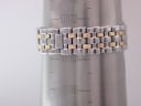 Tissot Ballade two-tone bracelet wrapped around a wrist sizing gauge, showing a circumference of 183mm or 18.3cm.