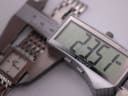 Digital caliper measuring the width of the Tissot L910 case, displaying a precise measurement of 23.5mm.