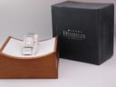 Michel Herbelin watch displayed in a wooden presentation box, with its original retail box behind it.