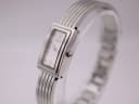 Side view of Michel Herbelin watch showing the rectangular case and integrated steel bangle bracelet.