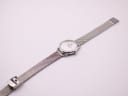 Top-down view of the Michel Herbelin watch with its silver milanese mesh bracelet fully extended on a white background.
