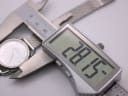 Digital caliper measuring the Michel Herbelin watch case diameter, showing a precise reading of 28.15mm.