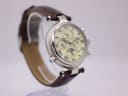 Another angled side view of Stauer watch on display stand, highlighting the strap attachment and pushers.