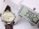 Digital caliper measuring the watch case diameter, displaying 38.02mm.