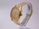 Side view of the Tissot Seastar, showcasing the gold-plated cushion case and crown with 'T' logo.