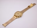 Long shot of the Tissot Seastar watch and full gold-tone mesh bracelet, showing its overall length.