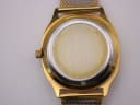 Close-up of the stainless steel case back with light surface marks.