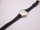 Rear view of the Bulova Longchamp watch with its black leather strap extended, showing the case back and buckle.