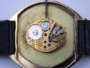 Macro view of the watch's manual wind movement, showing gears, jewels, and "SEVENTEEN 17 JEWELS N7 BULOVA WATCH CO" engraving.