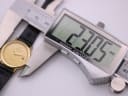 Digital caliper measuring the case diameter of the Raymond Weil watch at 23.05mm.