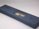 Close-up of the closed original blue Raymond Weil watch box, showing the embossed RW logo on the lid.