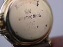 Extreme close-up of the watch case back, showing 'RAYMOND WEIL', '9955', 'A 451900', and '10M GOLD ELECTROPLATED' engravings.
