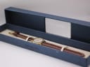 The Raymond Weil watch resting inside its original blue presentation box, with 'Raymond Weil Geneve' branding visible.