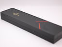 Top view of the closed original black Raymond Weil presentation box with red accents.