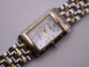 Close-up of the Raymond Weil Tango dial, featuring Roman numerals, diamond hour markers, gold-tone hands, and branding.