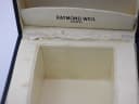 Interior view of the open Raymond Weil presentation box, showing the watch cushion and some wear to the lining.