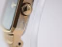 Close-up of the watch case side, revealing significant loss of gold plating and exposure of the silver-coloured base metal near the crown.
