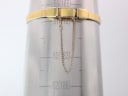 Close-up of the watch's integrated gold-tone bracelet on a wrist sizing gauge, indicating a wrist circumference of 165mm.