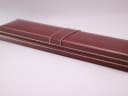 Closed view of the burgundy Mappin & Webb original presentation box with gold trim.