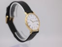Another angled side view of Mappin & Webb watch highlighting the slender gold-plated case and textured black leather strap.