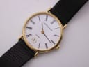 Close-up front view of the Mappin & Webb white dial with black Roman numerals, gold hands, and date window at 6 o'clock.
