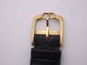 Close-up of the gold-tone buckle with "CD" logo and "Christian Dior" engraving.