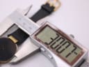 Digital caliper measuring the Christian Dior watch case diameter, displaying 32.07mm.