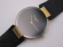 Close-up of the Christian Dior Dark Moon watch dial, revealing gold hands and "Christian Dior PARIS" logo.