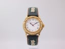 Front view of the Michel Jordi 1991 Cuvee CH watch with gold-tone case, white Roman numeral dial, date window, and a green embroidered leather strap.