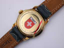 Close-up of the Michel Jordi watch case back, revealing "Water Resistant" engraving, a Swiss emblem sticker, and a red line stating "From the CEO, 8.12.1998".