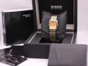 Front view of Rado Diastar two-tone watch with gold dial in its black original Rado presentation box, with papers and instruction manual.