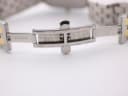 View of the open two-tone deployant clasp of the Rado bracelet, showing "RADO" and "stainless steel" engravings.