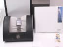 Rado Florence watch resting inside its original, worn black box, with accompanying papers laid out beside it.