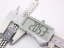 Digital caliper measuring the Rado Florence watch case, displaying an exact measurement of 20.53mm.
